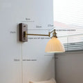 Adjustable brass wall sconce with ribbed glass shade bedroom light