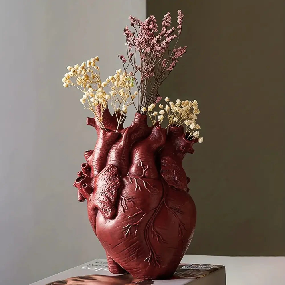 White anatomical heart vase with colorful flowers for living room