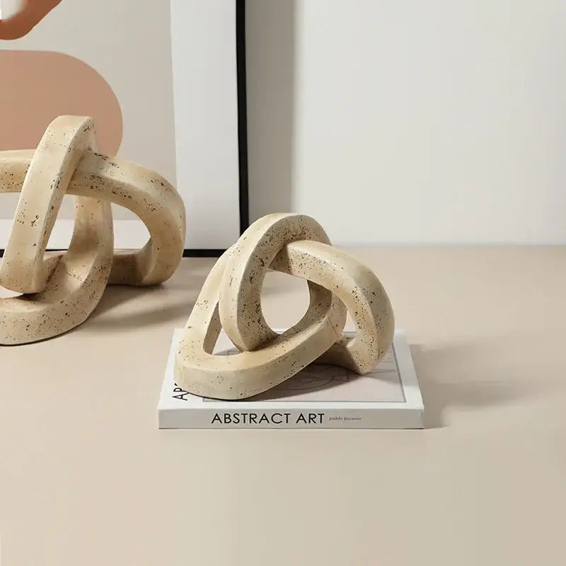 Beige speckled geometric interlocking loop knot living room sculpture