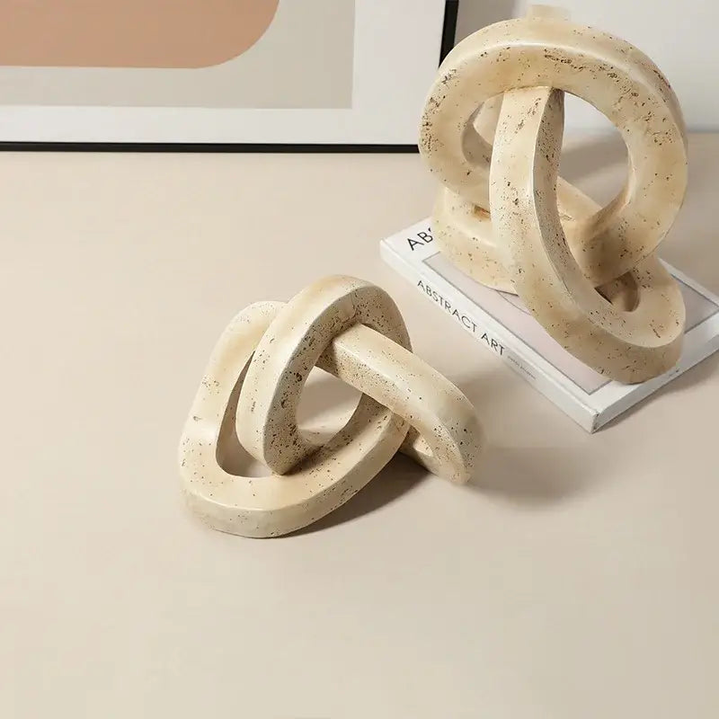 Beige speckled geometric interlocking loop knot living room sculpture