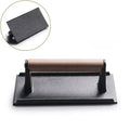 Black and light brown cast iron burger press kitchen meat tool
