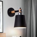 Black matte wall lamp with empire shade and wood arm for stairs