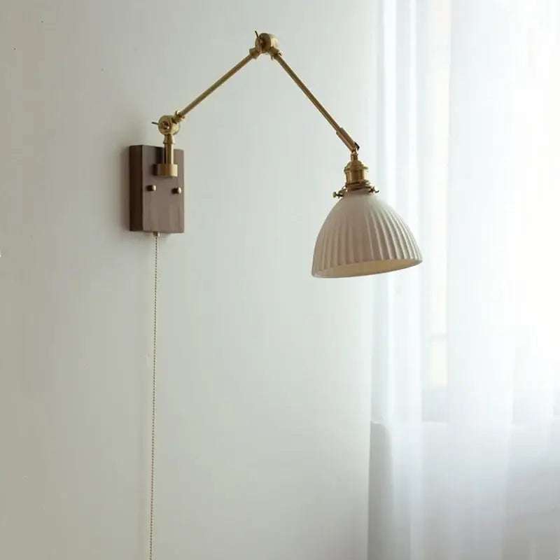 Brass walnut wall light with ribbed glass shade for bedroom