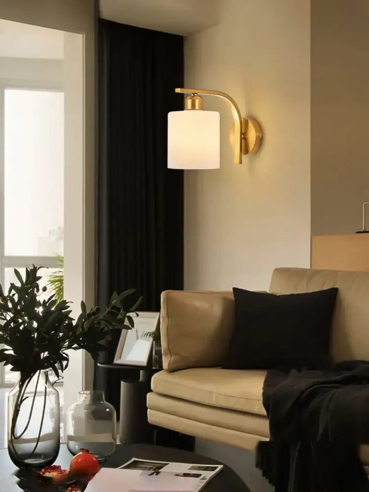 Classic brass glass wall sconce with frosted shade for bedroom