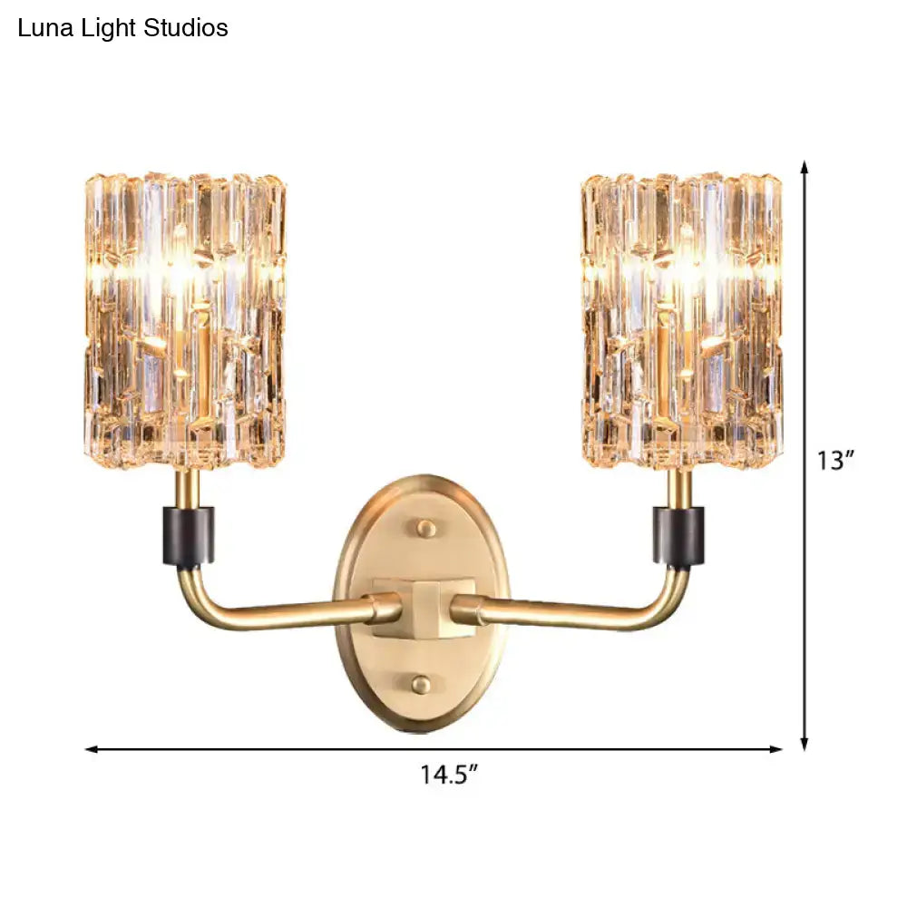 Contemporary brass bedside wall sconce with clear crystal shade bedroom