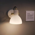 Contemporary brass & white glass wall lamp for bedroom with adjustable arm