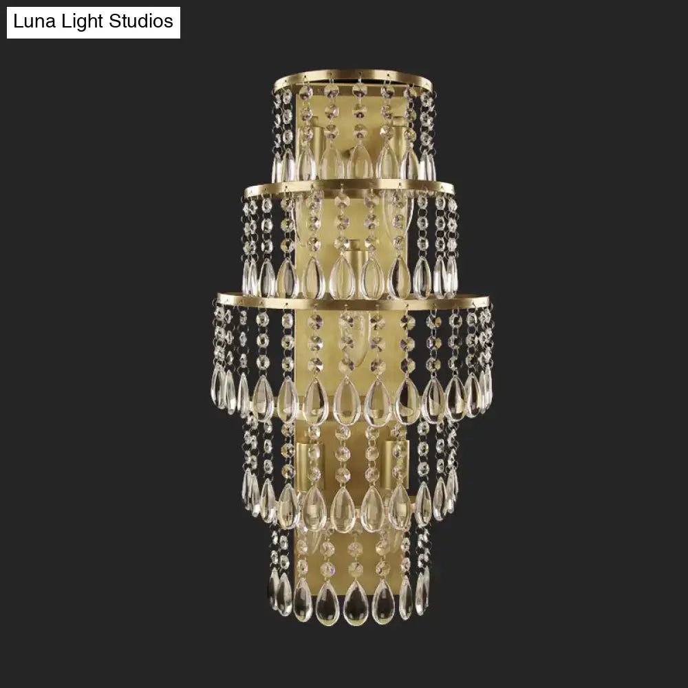 Contemporary gold layered bedside wall lamp with teardrop crystals