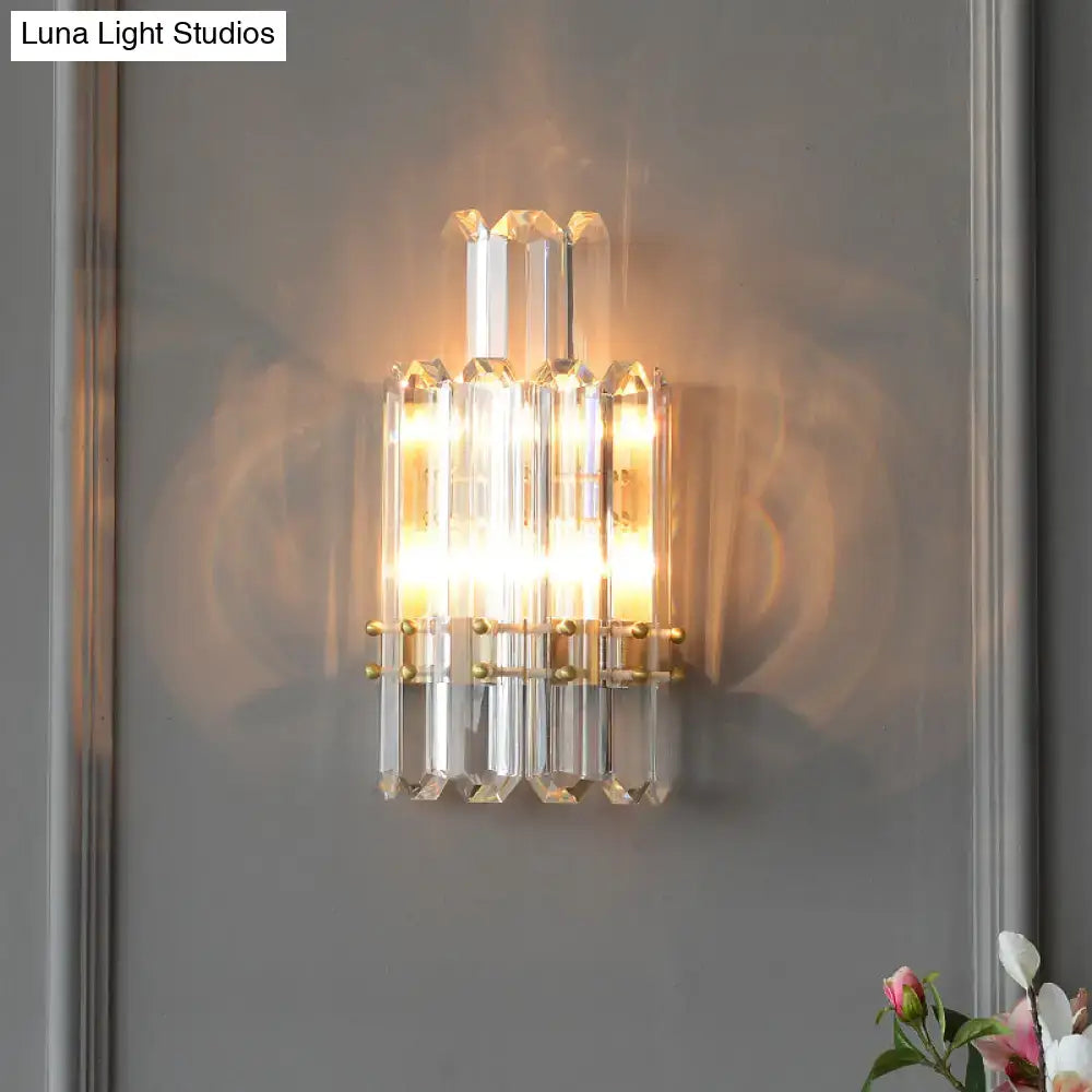 Contemporary gold wall sconce with clear crystal prisms for dining room