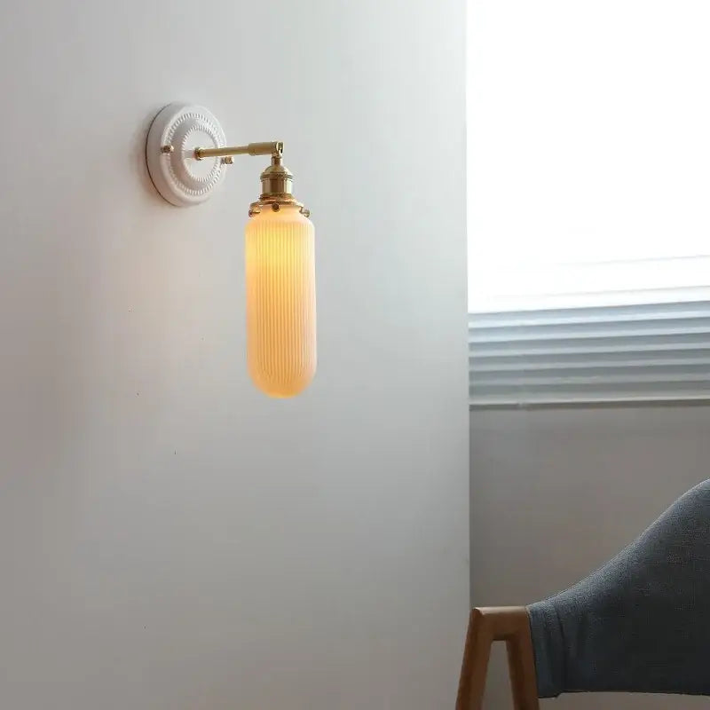 Cream ceramic led wall light with copper arm bedroom sconce