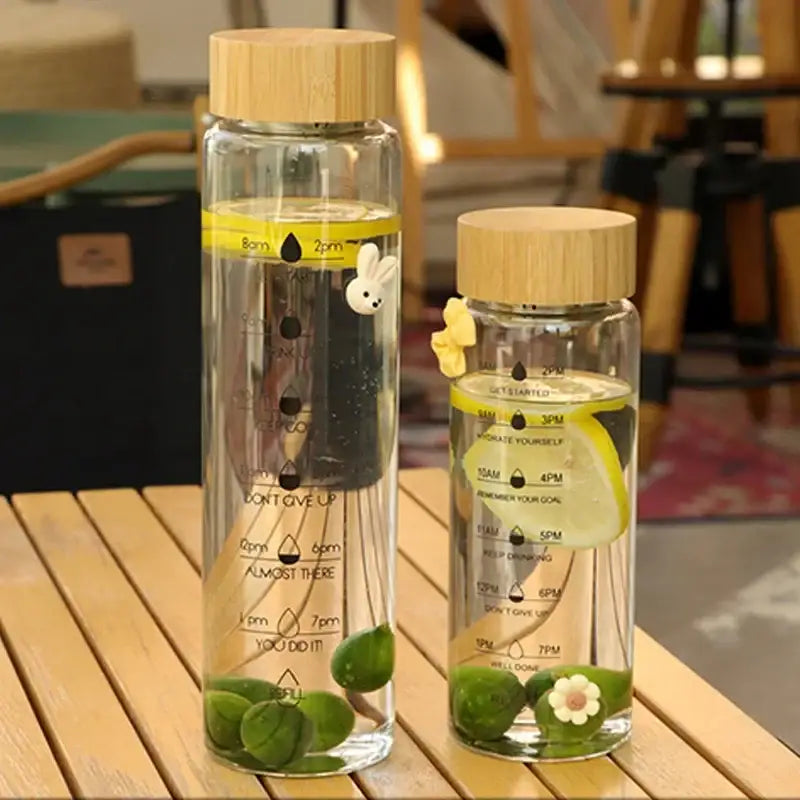 Minimalist glass water bottle with bamboo lid and kitchen time scale