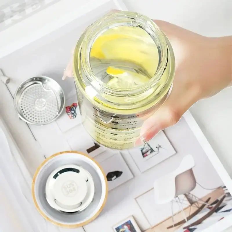 Minimalist glass water bottle with bamboo lid and kitchen time scale