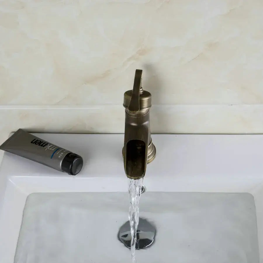 Antique brass waterfall basin faucet with art handle for bathroom