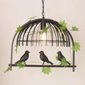 Rustic black birdcage pendant light dining room with vine and birds