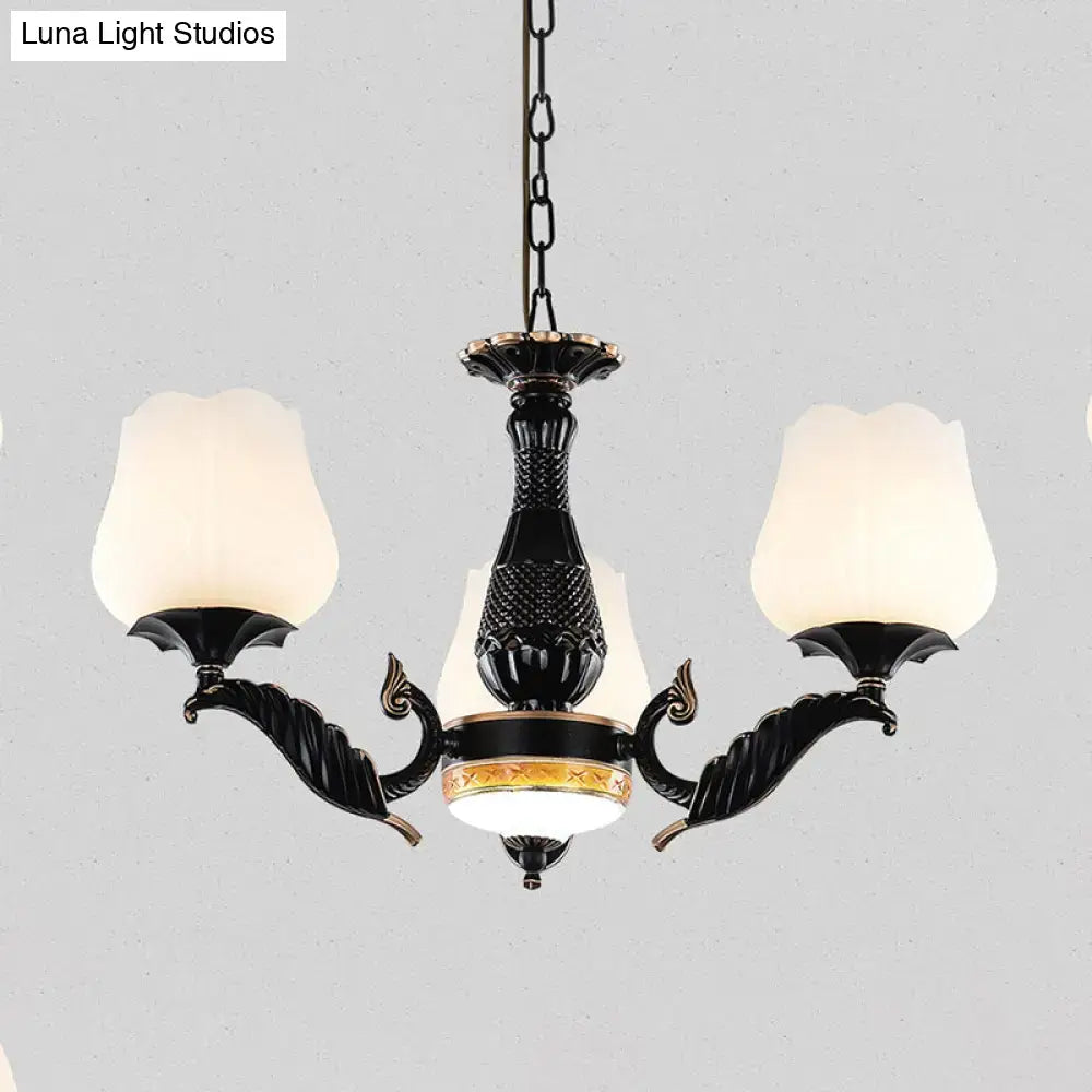 Ornate black & gold chandelier with frosted glass shades dining room