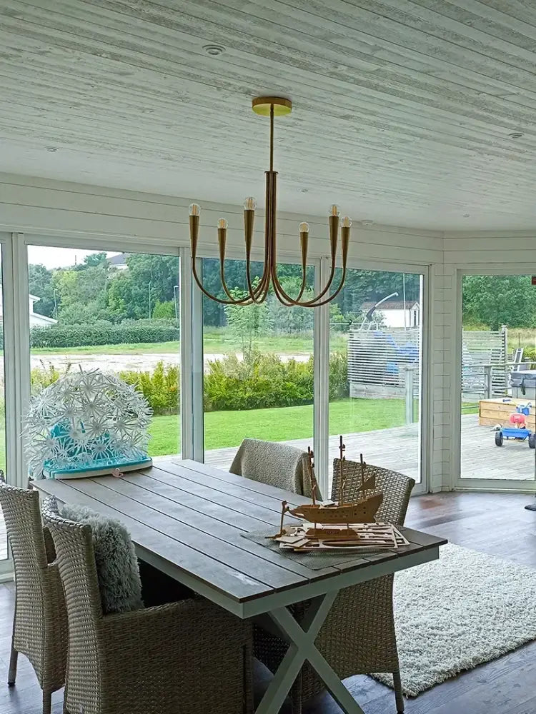 Decorbites brass chandelier for dining room with curved arms