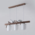 Modern wood island pendant with birds and cylindrical glass kitchen light