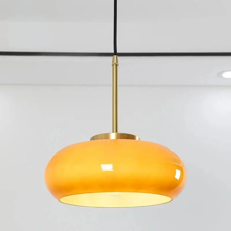 Sleek amber glass and copper pendant light for kitchens