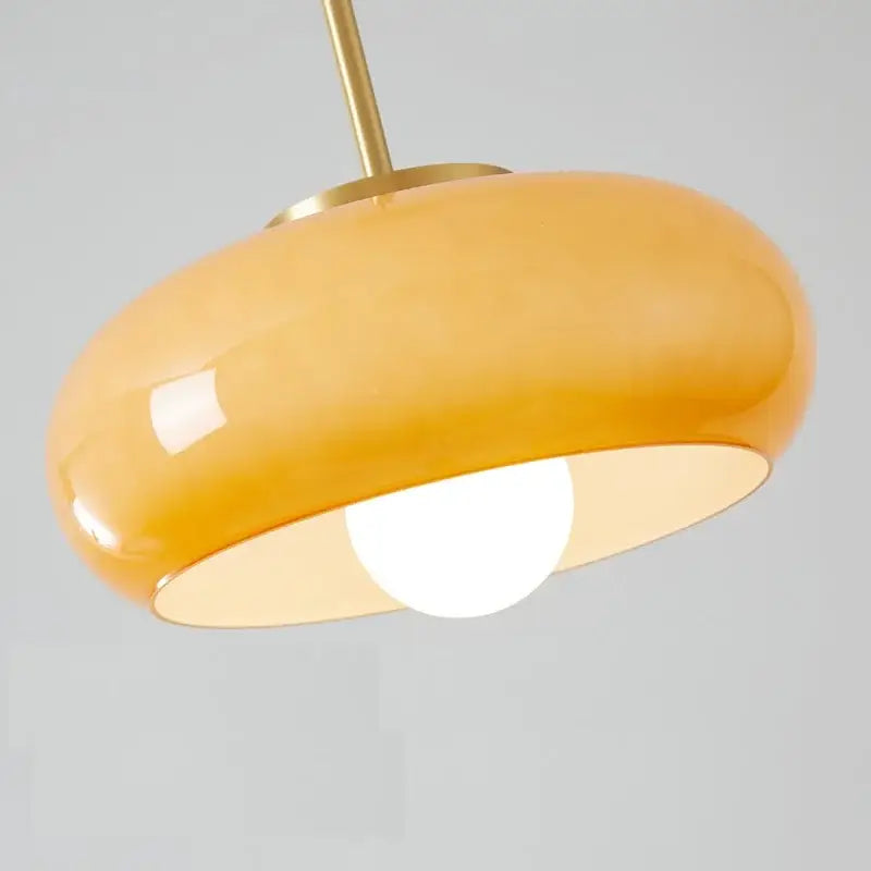 Sleek amber glass and copper pendant light for kitchens