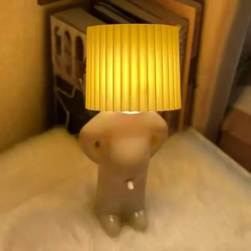 Whimsical beige and yellow naughty boy table lamp for bedroom bedside