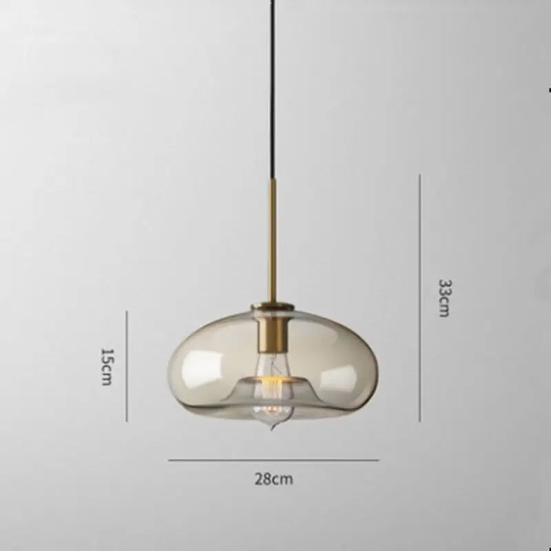 Modern smoked glass pendant lights with brass accents for kitchen island