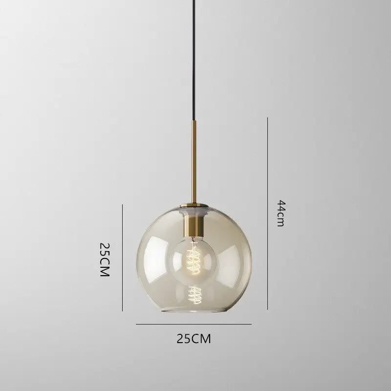 Modern smoked glass pendant lights with brass accents for kitchen island