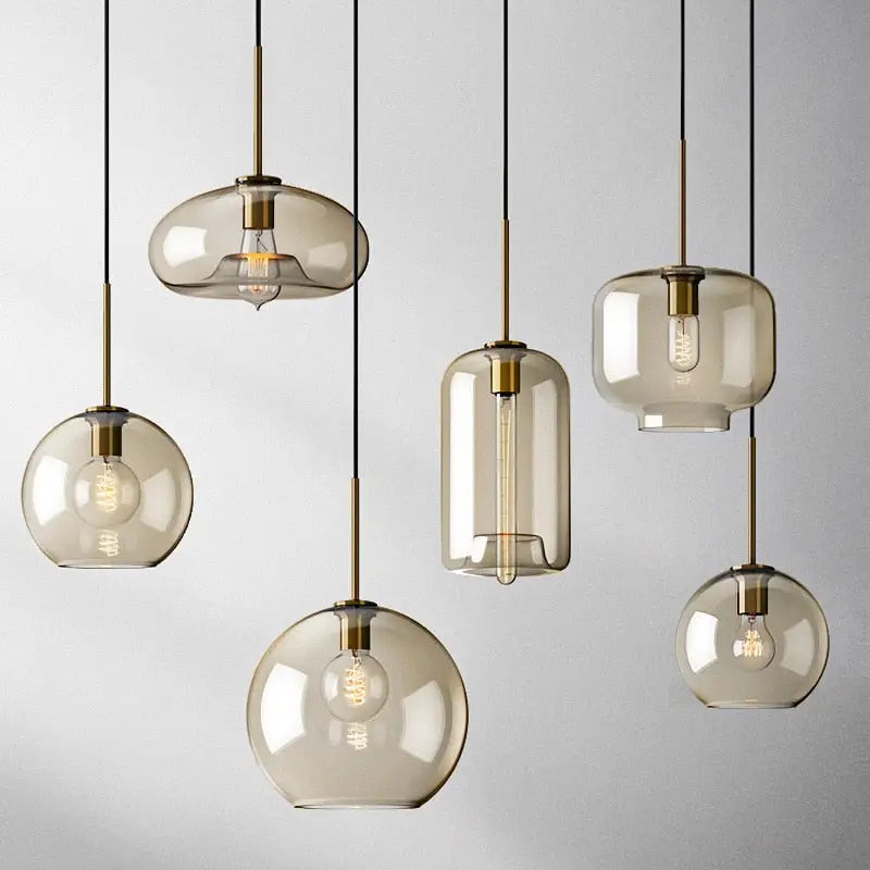 Modern smoked glass pendant lights with brass accents for kitchen island