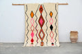 Handmade beige azilal rug with geometric patterns bedroom decor