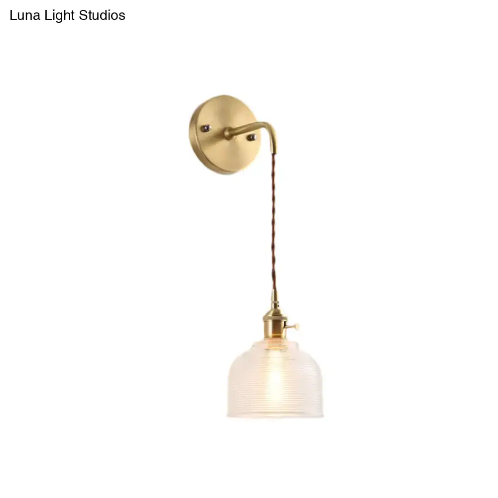 Industrial brass sconce with textured glass dome – bedroom light