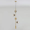 Modern gold linear chandelier with gray glass shades dining room