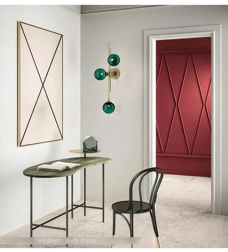 Modern gold wall sconce with textured glass globes for bedroom