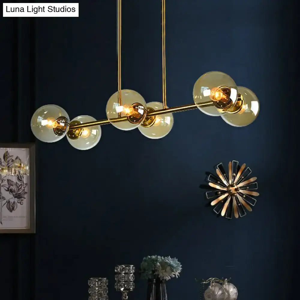 Postmodern gold kitchen island light with globe glass shade