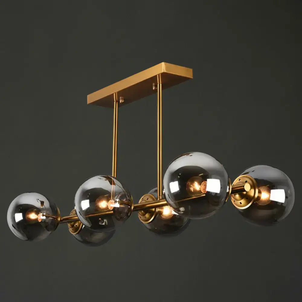 Postmodern gold kitchen island light with globe glass shade
