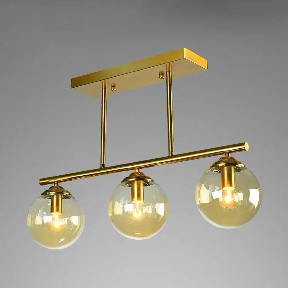 Postmodern gold kitchen island light with globe glass shade