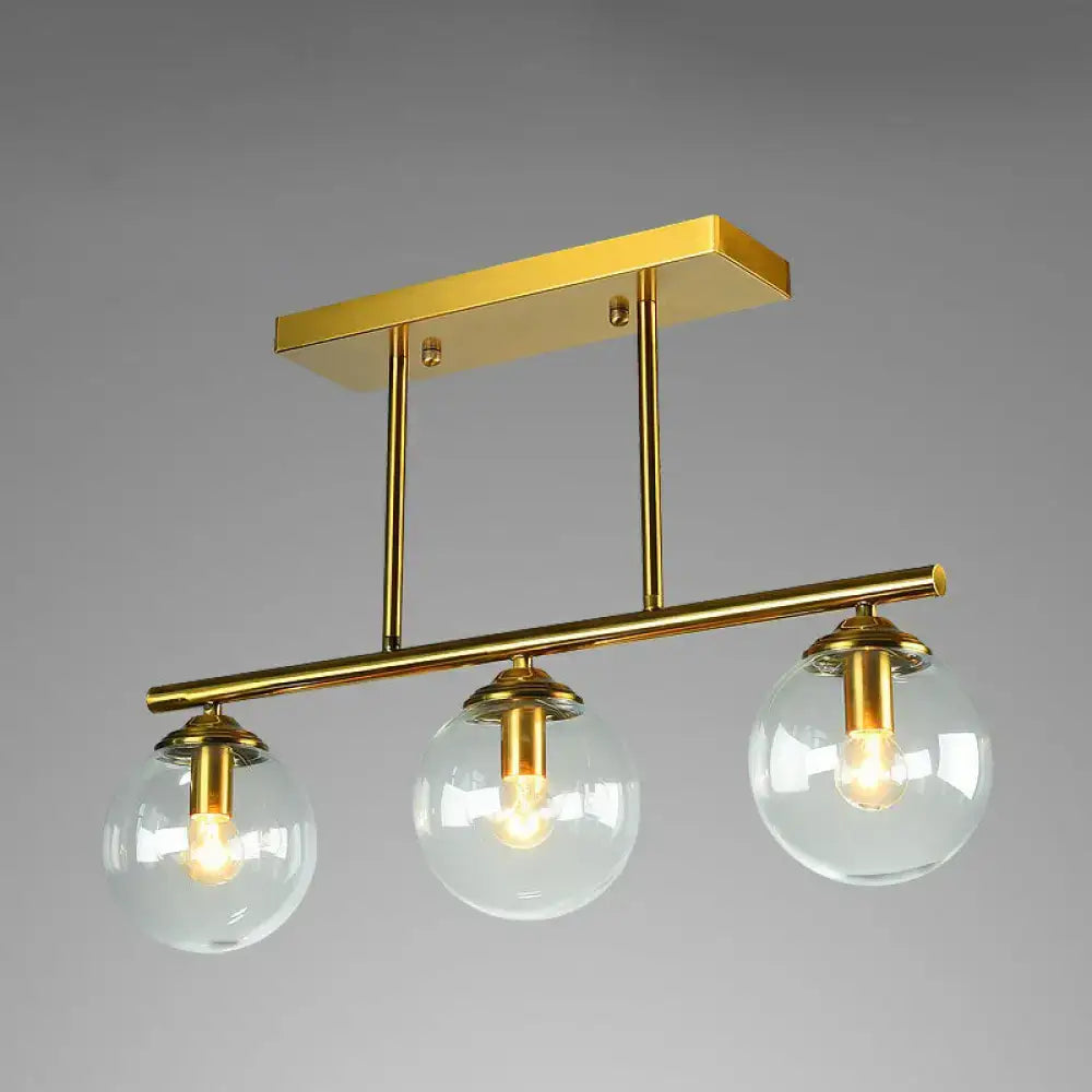 Postmodern gold kitchen island light with globe glass shade