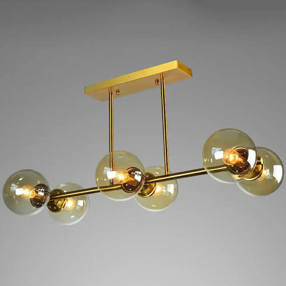 Postmodern gold kitchen island light with globe glass shade