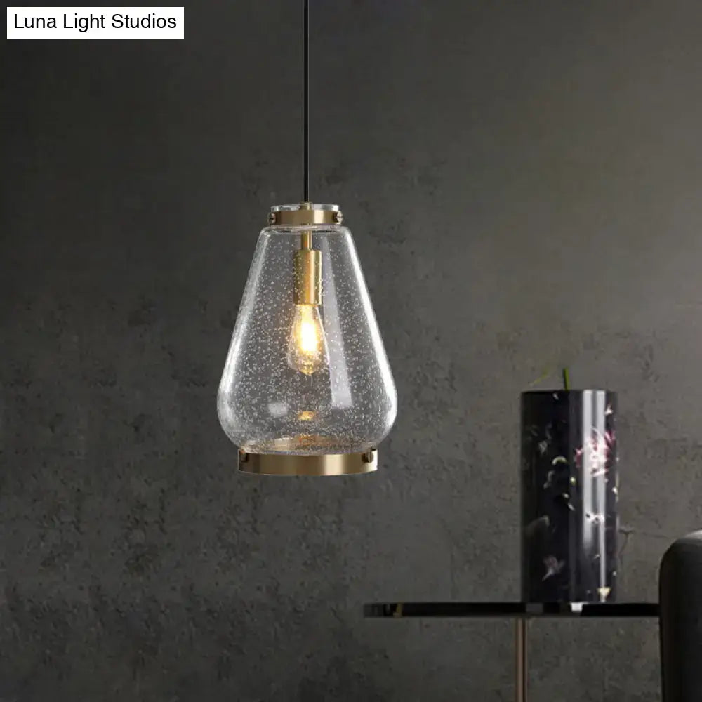 Modern seeded glass pendant light with brass rim bedroom