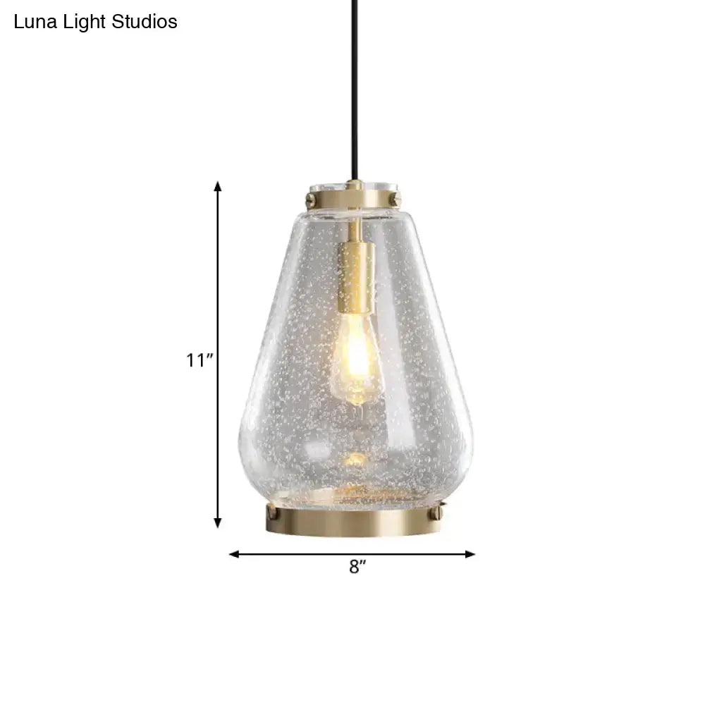 Modern seeded glass pendant light with brass rim bedroom