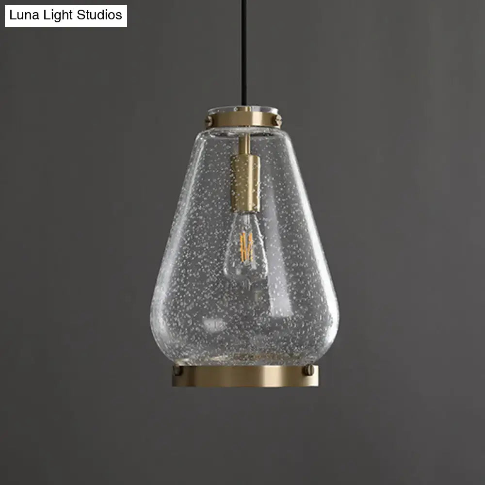 Modern seeded glass pendant light with brass rim bedroom