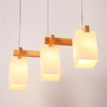 Minimalist wood island pendant light with opaline glass dining room