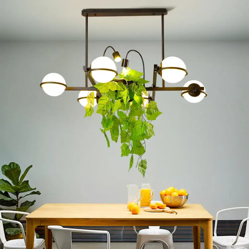 Vintage black and white island lighting fixture with plant for kitchen