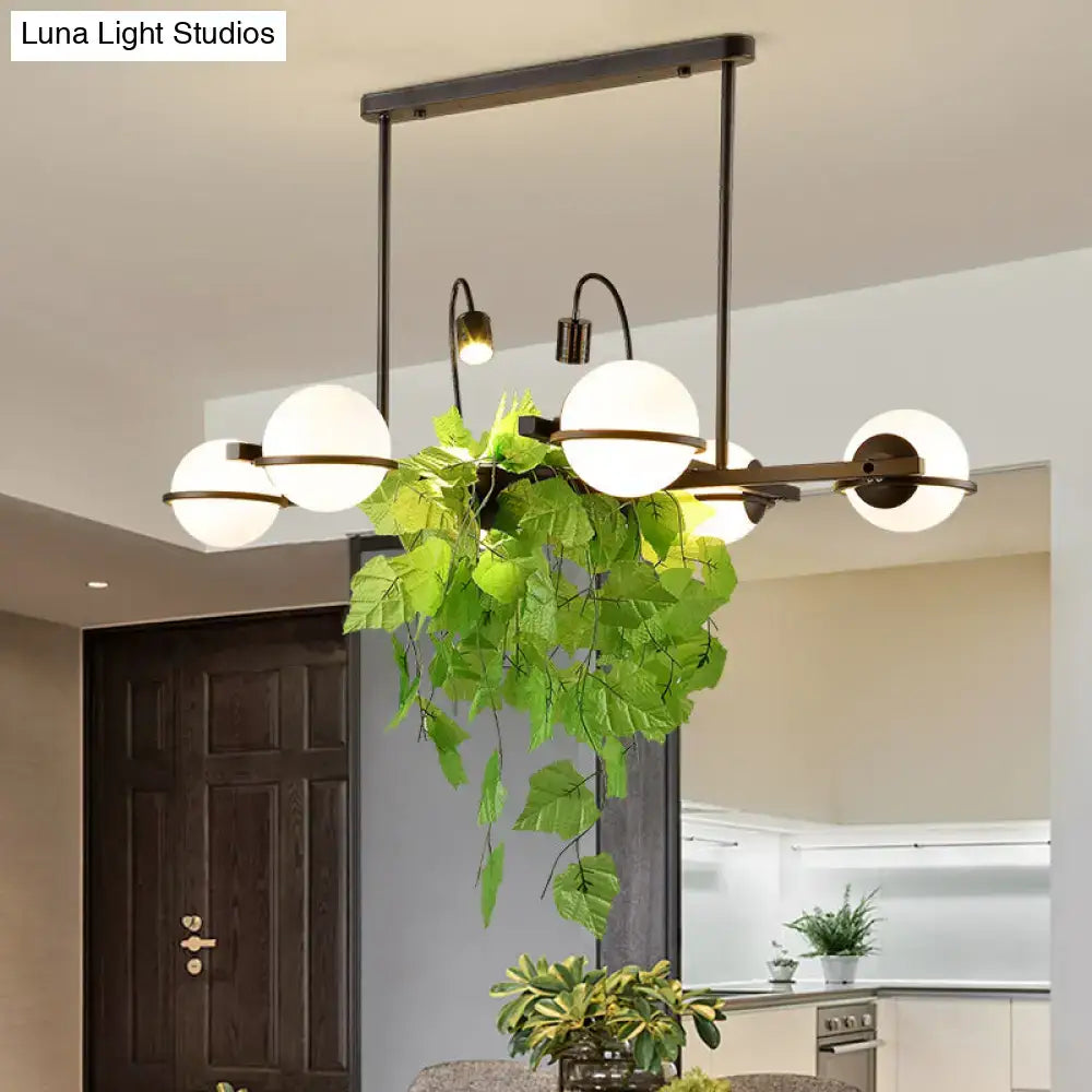 Vintage black and white island lighting fixture with plant for kitchen