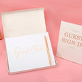 Elegant white guest book with bronzing detail – wedding reception