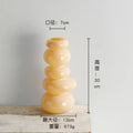 Glossy pastel pink pebble stack floral arrangement living room vase