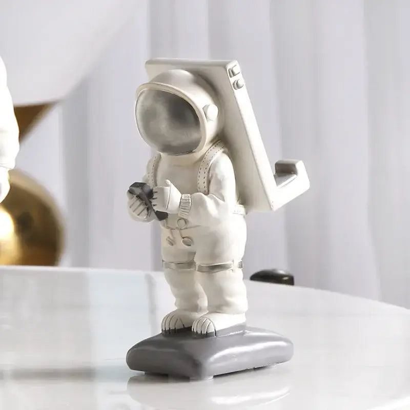 Glossy white and gold astronaut phone holder bedroom decor sculpture