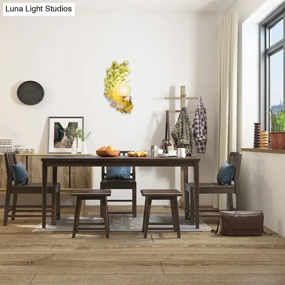 Golden peacock wall light with crystal shade – living room yellow & green