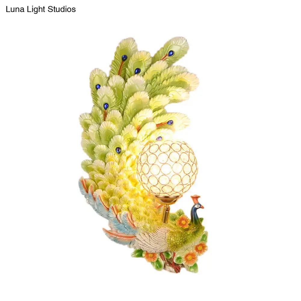 Golden peacock wall light with crystal shade – living room yellow & green