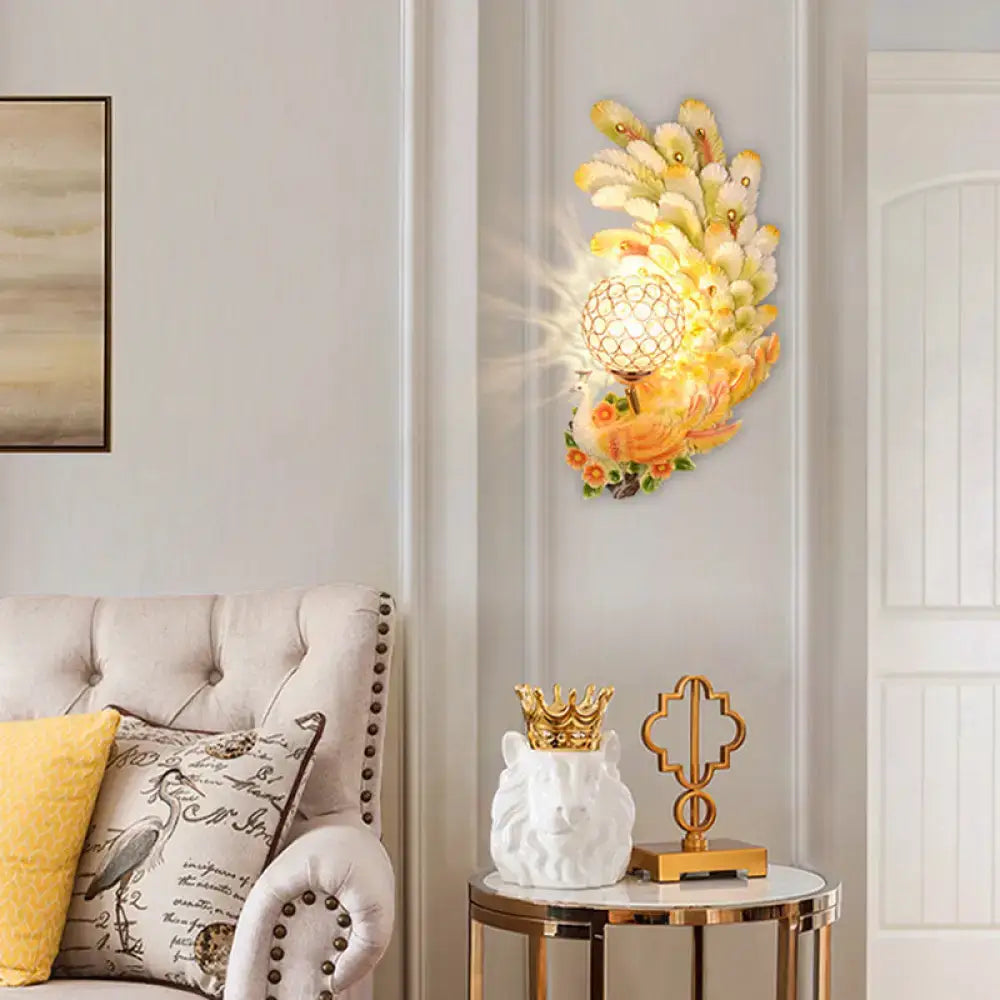 Golden peacock wall light with crystal shade – living room yellow & green