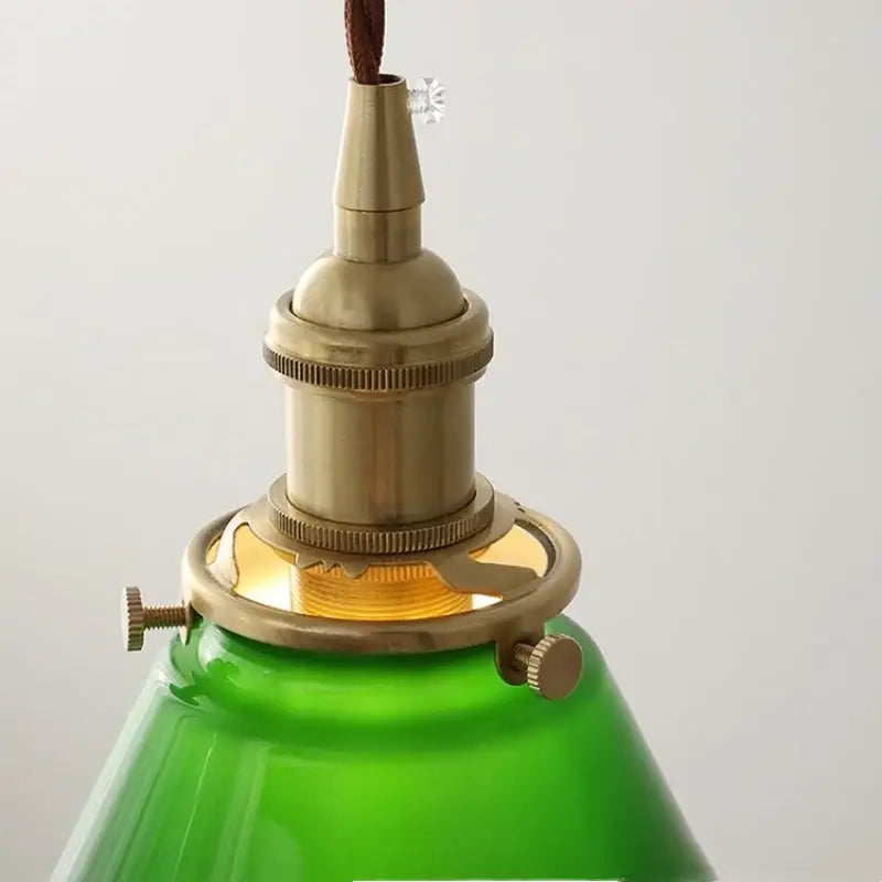 Green glass pendant light with copper canopy for dining room