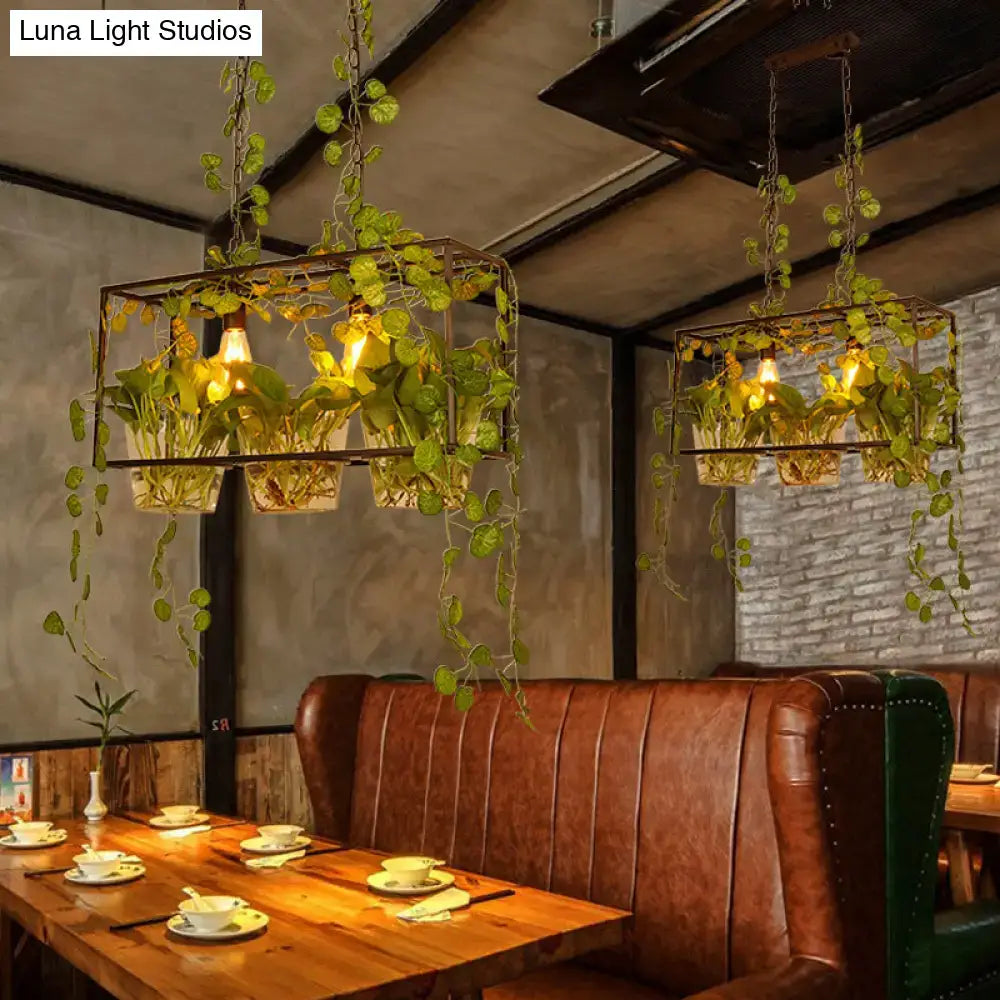 Industrial black island pendant light with potted plant dining room