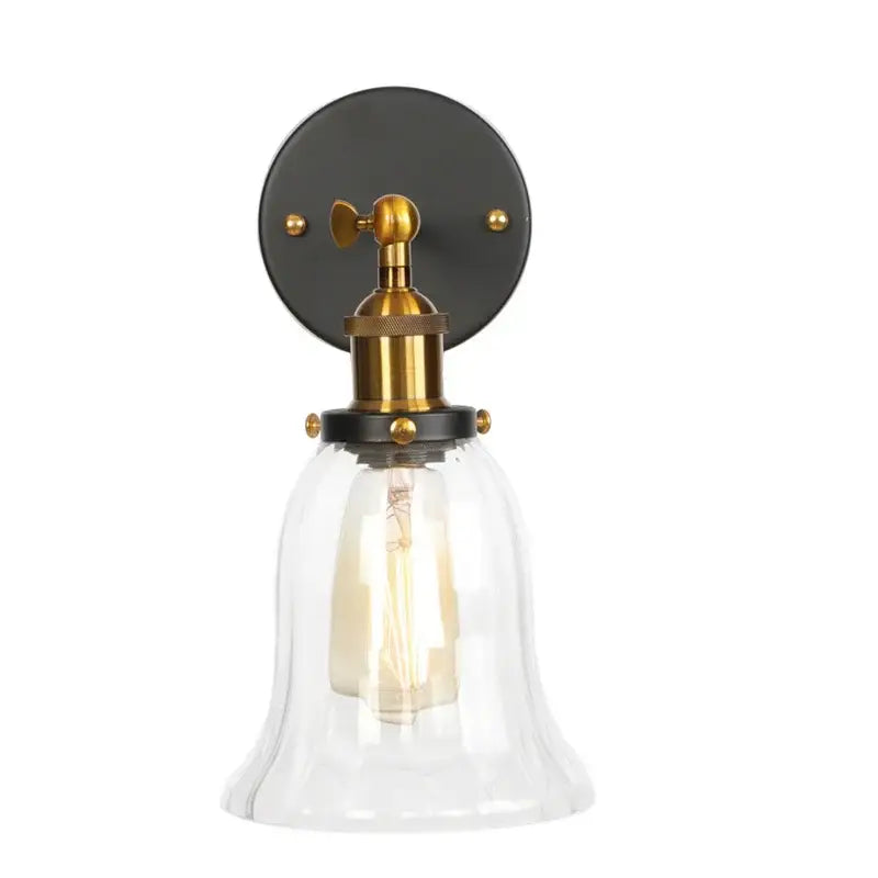 Industrial brass and clear glass wall sconce for bedroom